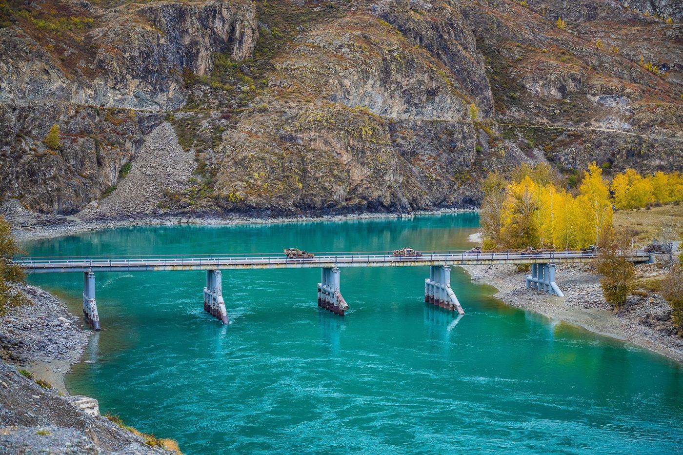 Turquoise Katun river and bridge in the Altai mountains on the MadWay Rally route