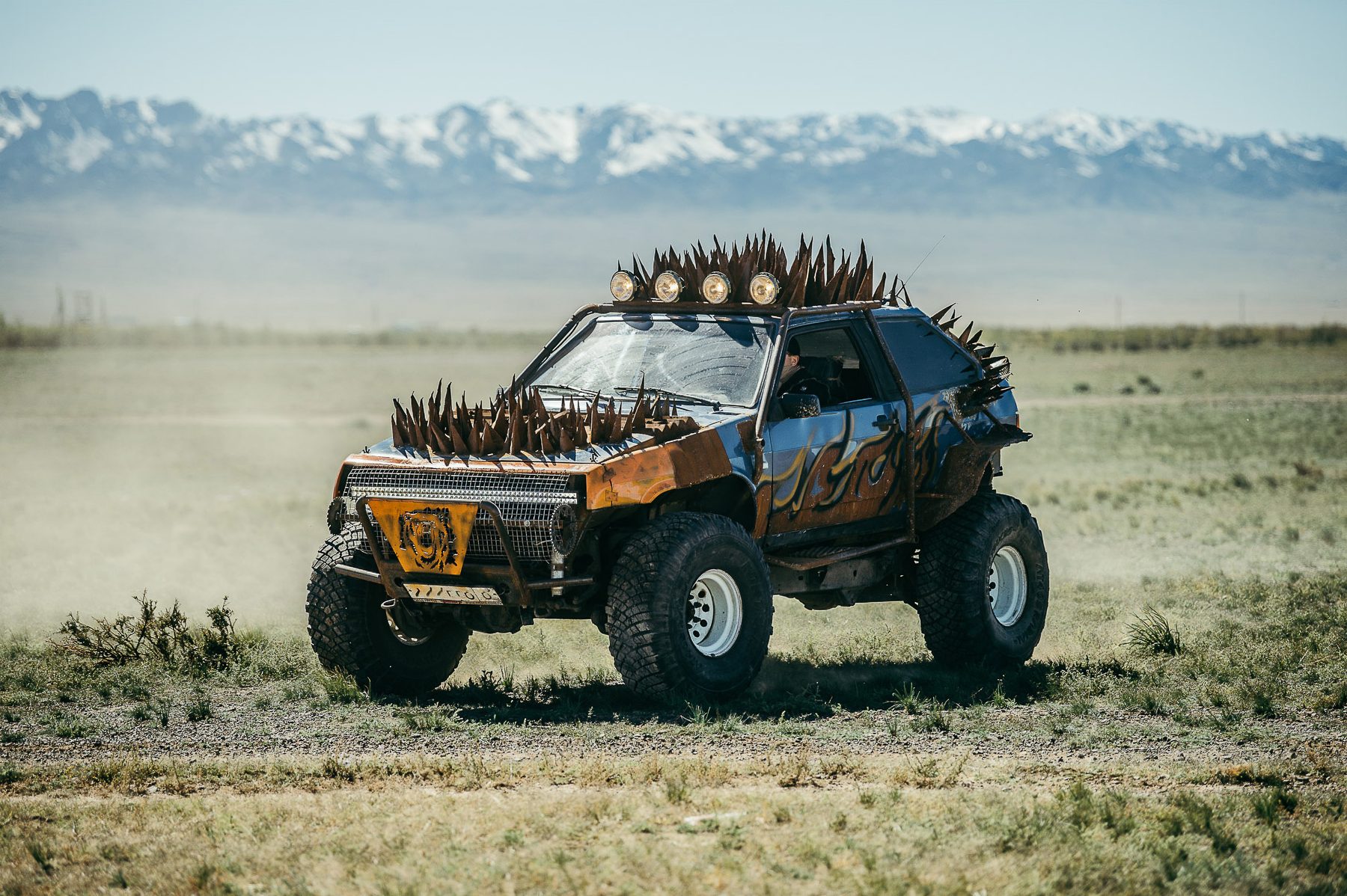 MadWay Rally custom car with spikes and armor against snowy mountains