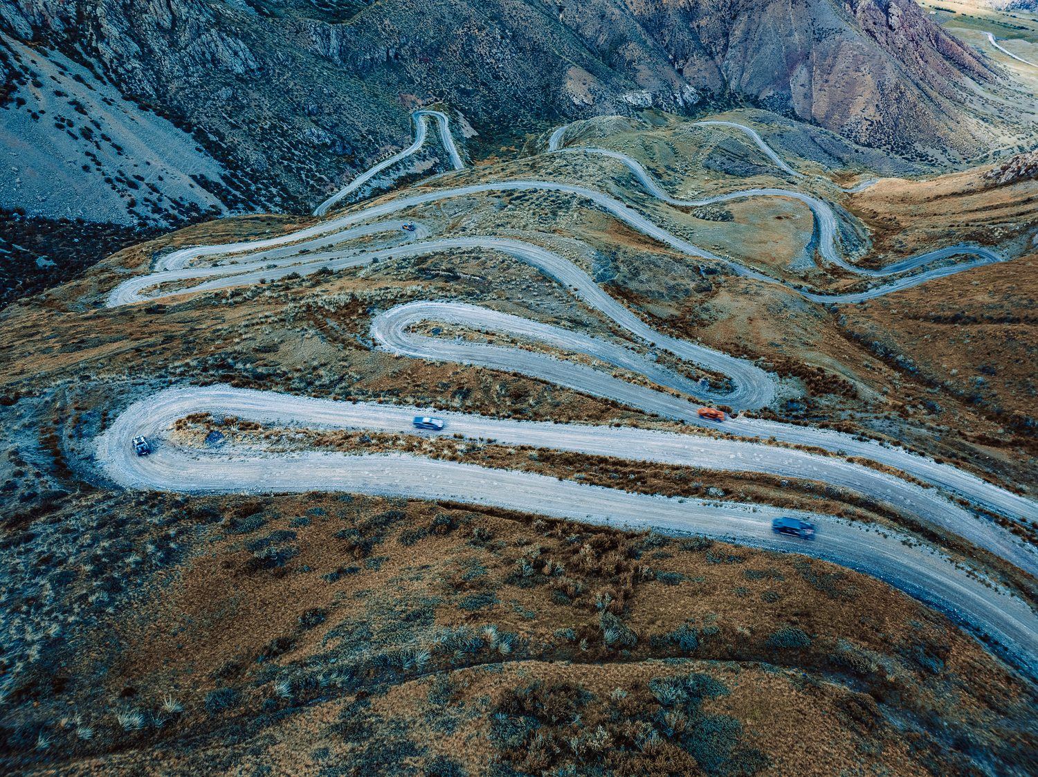 Aerial view of the MadWay Rally convoy on a mountain serpentine road in China