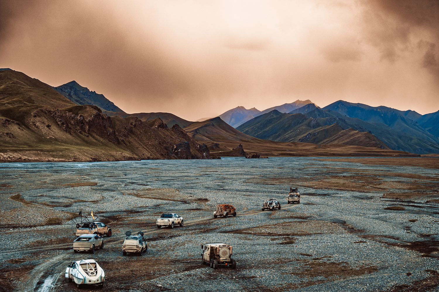 MadWay Rally convoy on a riverbed plain under a storm sky in China