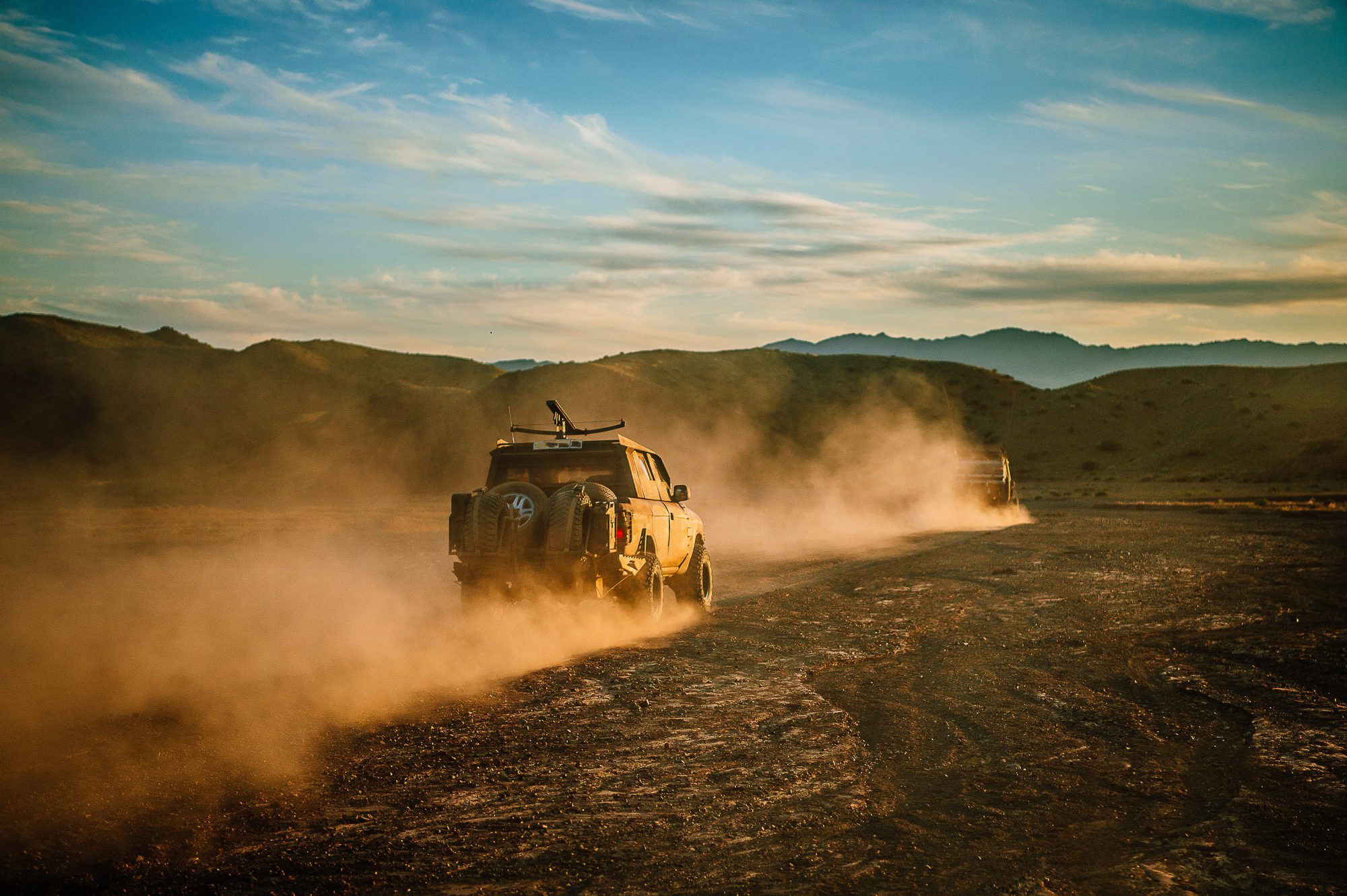 MadWay Rally car raising dust at dusk in the steppe