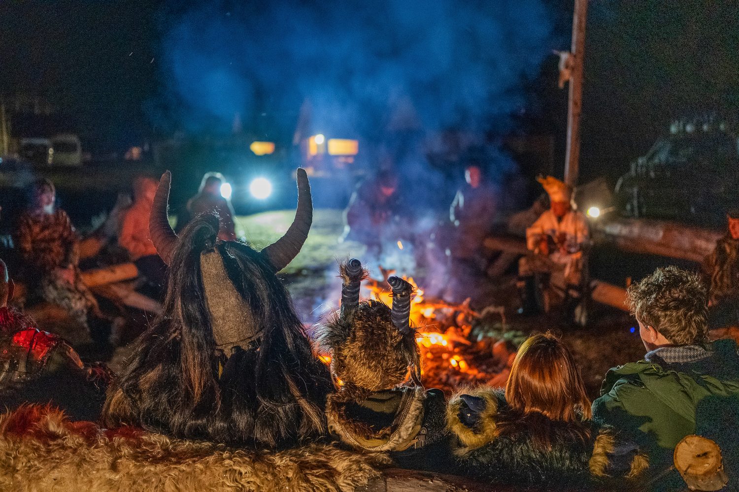 MadWay Rally participants in post-apocalyptic costumes around a night campfire in Mongolia