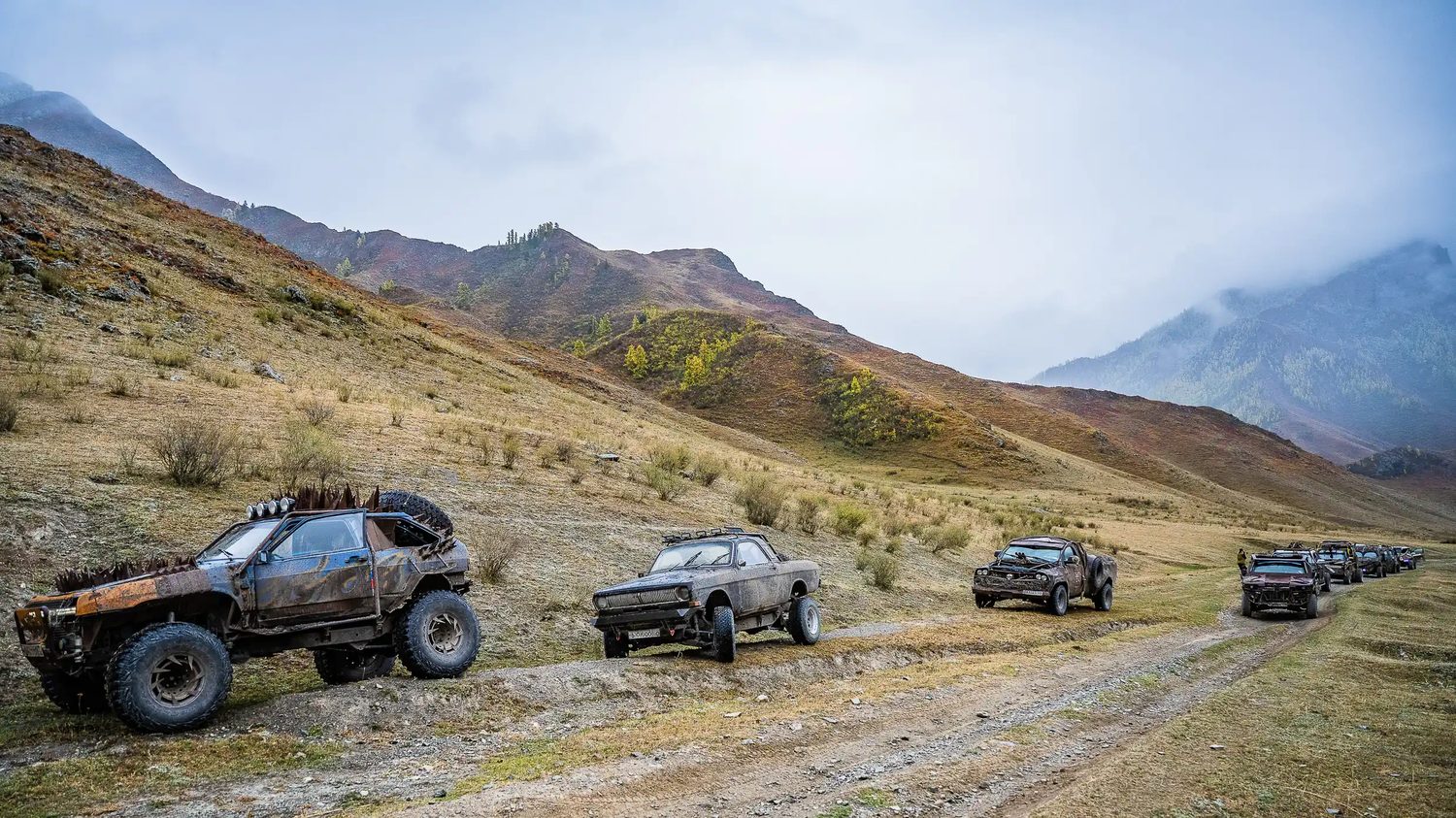 MadWay Rally convoy of custom cars crossing a mountain pass in Kyrgyzstan